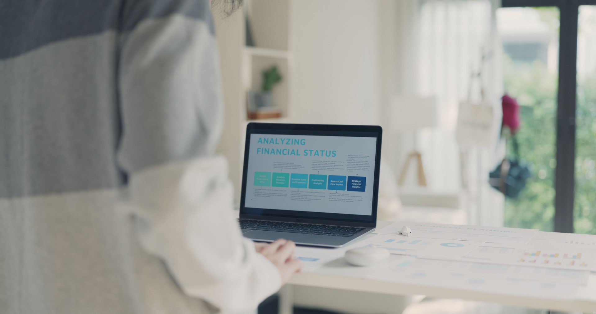 Professional Reviewing Financial Status on Laptop Screen.